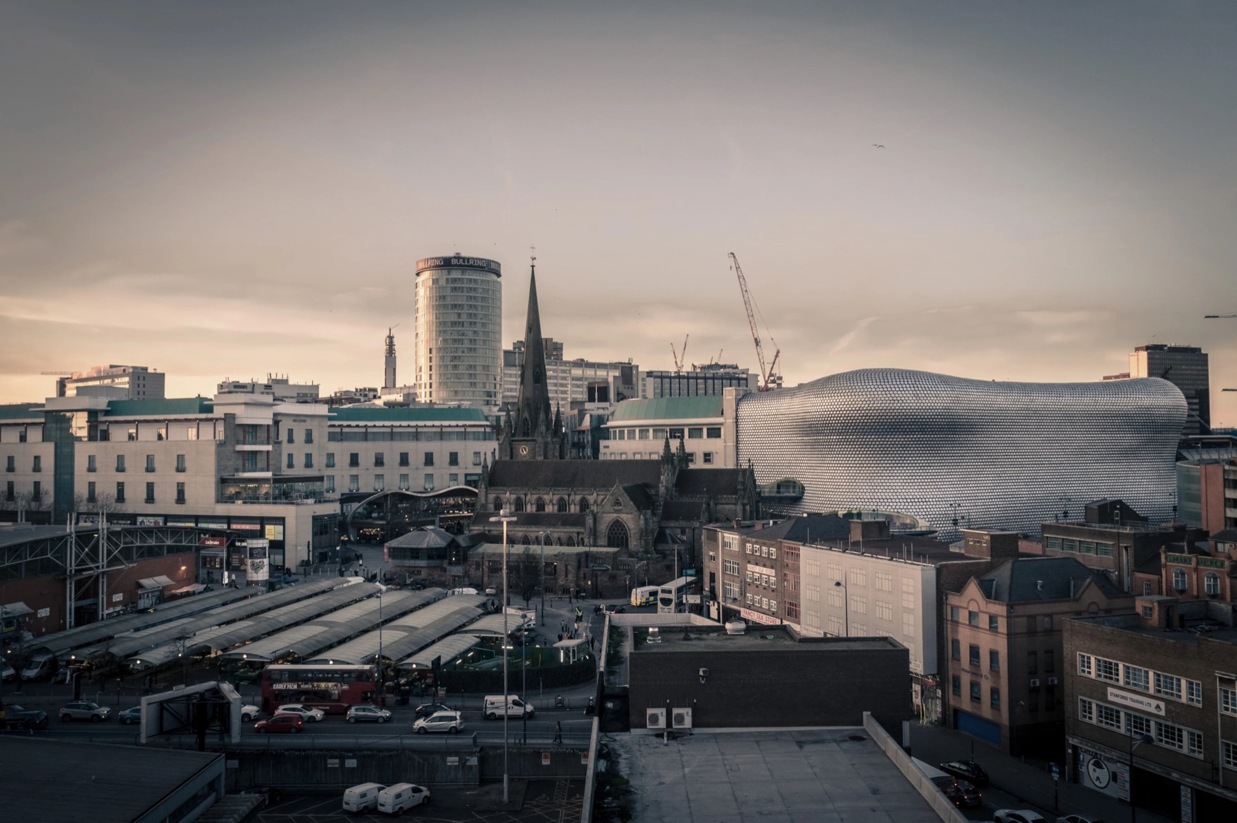 Birmingham city centre skyline at dusk, featuring the Bullring and St Martin's Church